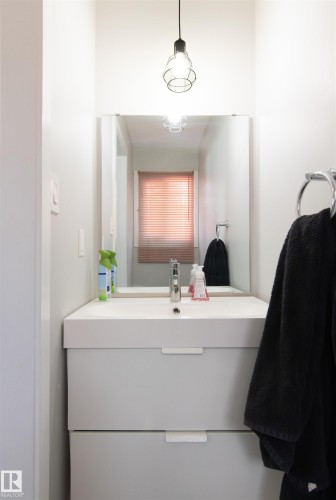 Compact bathroom vanity featuring an integrated basin, chrome faucet, and two storage drawers - 7115 39A Avenue, Edmonton, AB - Indoor Photo Showing Bathroom