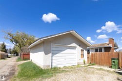 Detached garage with a single overhead door and stucco exterior - 