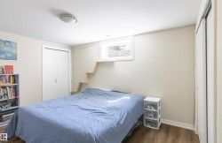 Room with wood-finish flooring, a flush-mount ceiling light, and a white-framed window - 