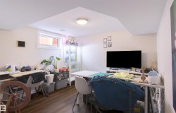 Finished room featuring wood-finish flooring, a ceiling-mounted light fixture, and a window providing natural illumination - 