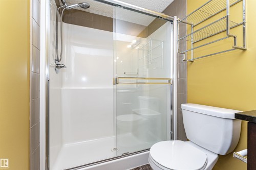 Walk-in shower with a glass enclosure and chrome fixtures - 404 12045 22 Avenue, Edmonton, AB 