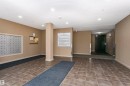 Building foyer featuring tile flooring, neutral wall tones, recessed lighting, and individual mailboxes - 404 12045 22 Avenue, Edmonton, AB 