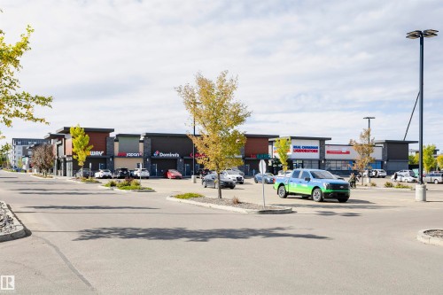Modern commercial complex featuring diverse retail storefronts - 404 12045 22 Avenue, Edmonton, AB 