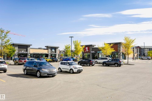 Retail complex featuring diverse storefronts with stone and dark panel facades - 404 12045 22 Avenue, Edmonton, AB 
