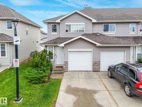 Light gray siding exterior with stone accenting - 18 230 Edwards Drive, Edmonton, AB 