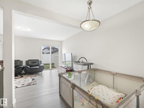 Bright interior space featuring light wood-finish flooring - 18 230 Edwards Drive, Edmonton, AB 