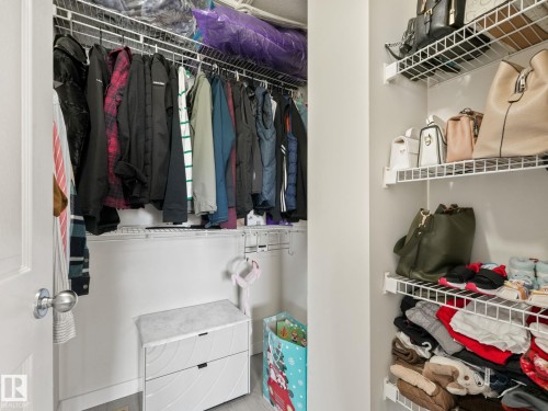 Efficient closet organization system featuring multiple wire shelving units and hanging rods - 18 230 Edwards Drive, Edmonton, AB 