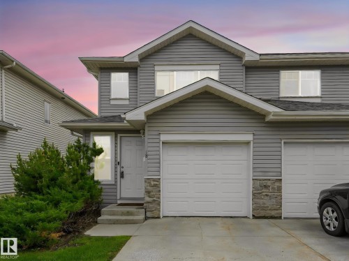 Gray siding exterior with stone accents - 18 230 Edwards Drive, Edmonton, AB 