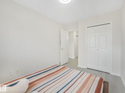 Room featuring light gray wood-finish flooring, white walls, and a ceiling-mounted light fixture - 