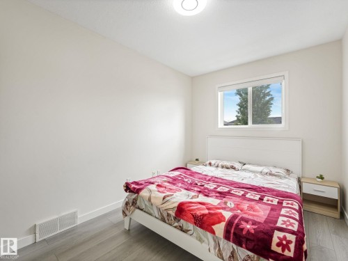 Interior room with light-toned walls and wood-finish flooring - 18 230 Edwards Drive, Edmonton, AB 