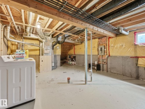 Unfinished basement with concrete flooring and exposed ceiling joists - 18 230 Edwards Drive, Edmonton, AB 