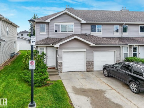 Gray siding exterior with stone accents - 18 230 Edwards Drive, Edmonton, AB 