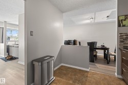 Open-concept living space with light wood-finish flooring - 