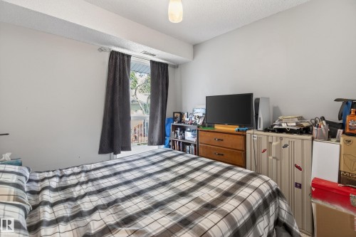 Bright room featuring a window with dark curtains, white walls, and a textured ceiling - 35 3111 142 Avenue, Edmonton, AB 