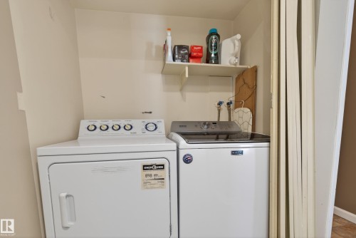 Dedicated laundry area featuring white washer and dryer units - 35 3111 142 Avenue, Edmonton, AB 