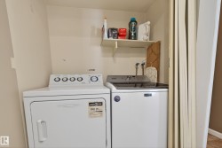 Dedicated laundry area featuring white washer and dryer units - 