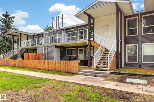Multi-level exterior featuring dark brown siding, stucco accents, and white railings - 35 3111 142 Avenue, Edmonton, AB 
