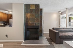 Statement fireplace featuring stacked slate tile surround and hearth - 