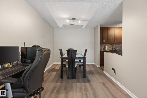 Open-concept living space featuring wood-finish flooring throughout - 35 3111 142 Avenue, Edmonton, AB 
