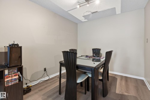 Dining area featuring wood-finish flooring, neutral wall paint, and white baseboards - 35 3111 142 Avenue, Edmonton, AB 