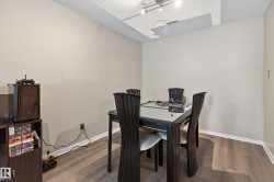 Dining area featuring wood-finish flooring, neutral wall paint, and white baseboards - 