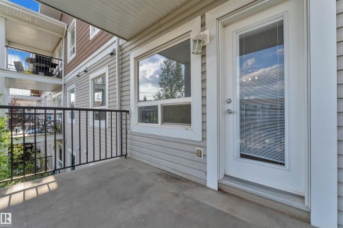 Private balcony featuring concrete flooring, black metal railing, and direct access through a full-light glass door - 3302 9351 Simpson Drive, Edmonton, AB 