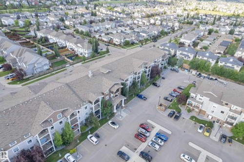 Multi-story apartment building with balconies, exterior siding, and a large parking area - 3302 9351 Simpson Drive, Edmonton, AB 