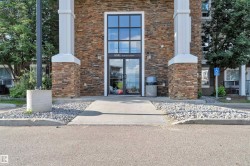 Building exterior featuring stacked stone cladding with white column accents - 