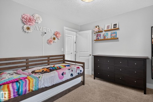 Carpeted room featuring light gray walls and a textured ceiling - 14016 161 Avenue, Edmonton, AB 