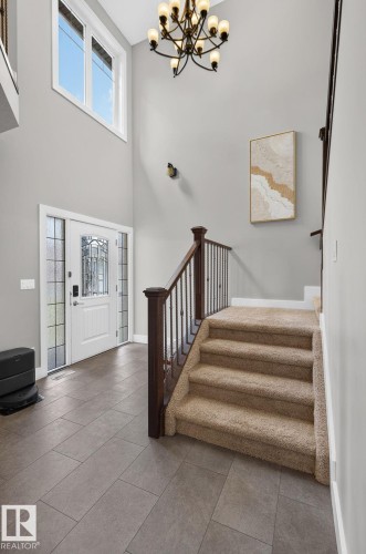 Entry foyer with high ceilings and a prominent chandelier - 14016 161 Avenue, Edmonton, AB 