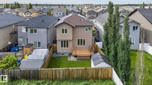Rear exterior featuring a multi-level wood deck, a manicured lawn, and a wood privacy fence - 14016 161 Avenue, Edmonton, AB 