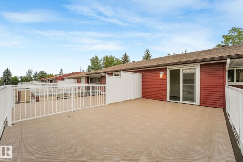 Spacious outdoor patio featuring durable flooring and white railing - 2921 130 Avenue, Edmonton, AB 