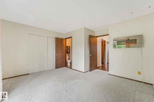 Primary bedroom featuring a 2 piece ensuite and Juliet style balcony. - 2921 130 Avenue, Edmonton, AB 