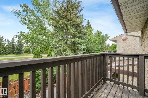 Balcony featuring stained wood railing and decking - 2921 130 Avenue, Edmonton, AB 
