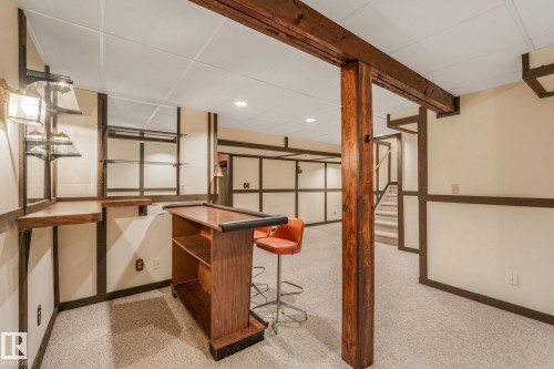Bar with built-in shelving and sconce lighting. - 2921 130 Avenue, Edmonton, AB 