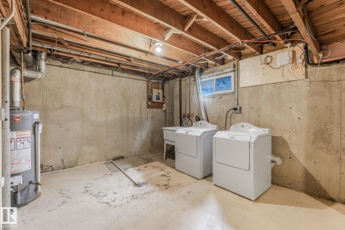 Laundry area with washer, dryer and utility sink. - 2921 130 Avenue, Edmonton, AB 