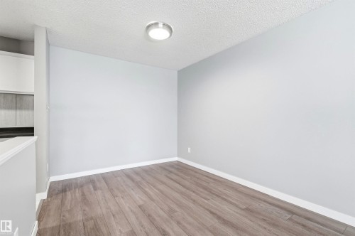 Spacious interior featuring wood-finish flooring, light gray wall paint, and white baseboards - 2005 Saddleback Road, Edmonton, AB - Indoor Photo Showing Other Room