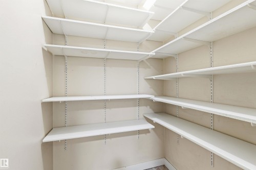 Walk-in pantry featuring expansive shelving, adjustable white wire shelving, light-toned wall paint, and L-shaped configuration - 2005 Saddleback Road, Edmonton, AB - Indoor With Storage