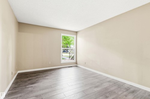 Spacious room featuring wood-finish flooring and neutral wall tones - 2005 Saddleback Road, Edmonton, AB - Indoor Photo Showing Other Room