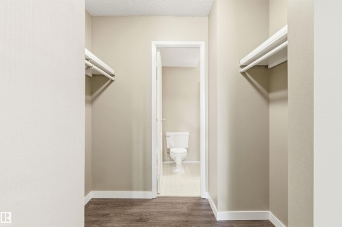 Interior hallway featuring wood-finish flooring, light neutral wall paint, and white baseboards - 2005 Saddleback Road, Edmonton, AB - Indoor Photo Showing Other Room