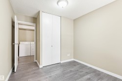 Room featuring wood-finish flooring, neutral wall tones, and a built-in closet with bifold doors - 