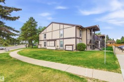Two-story multifamily building with tan siding and brown trim - 
