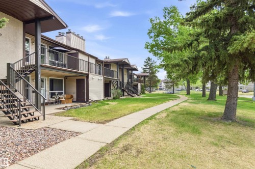 Exterior of a multi-unit property featuring light-toned siding and dark trim - 2005 Saddleback Road, Edmonton, AB - Outdoor