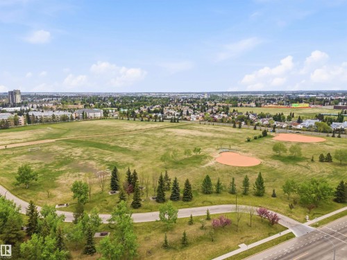 Expansive green space featuring two baseball diamonds, paved walking paths, a variety of mature trees, and landscaping - 2005 Saddleback Road, Edmonton, AB - Outdoor With View