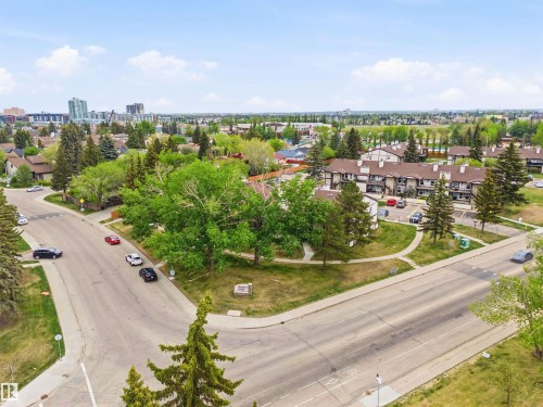 Aerial perspective showcasing a residential area with mature trees and a distant urban skyline - 2005 Saddleback Road, Edmonton, AB - Outdoor With View
