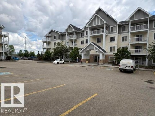 Multi-story residential building featuring a gabled roofline and multiple private balconies - 210 2204 44 Avenue, Edmonton, AB 