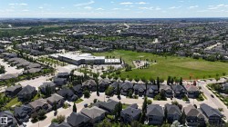 Expansive residential area featuring numerous detached homes with dark roofs and varied architectural styles - 