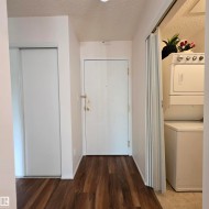 Entryway featuring wood-finish flooring, white walls, and a recessed ceiling light - 