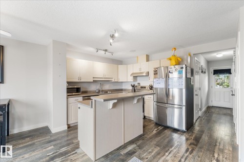 Contemporary kitchen featuring light wood-finish cabinetry and stainless steel appliances - 2324 30 Avenue, Edmonton, AB 