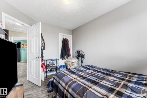 Room featuring light gray walls and wood-finish flooring - 2324 30 Avenue, Edmonton, AB 